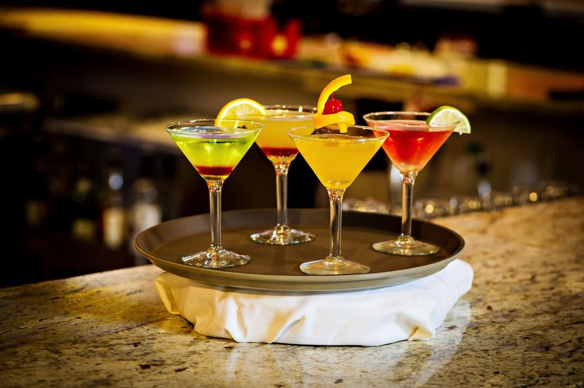 A tray of colorful hand-crafted martinis on the bar