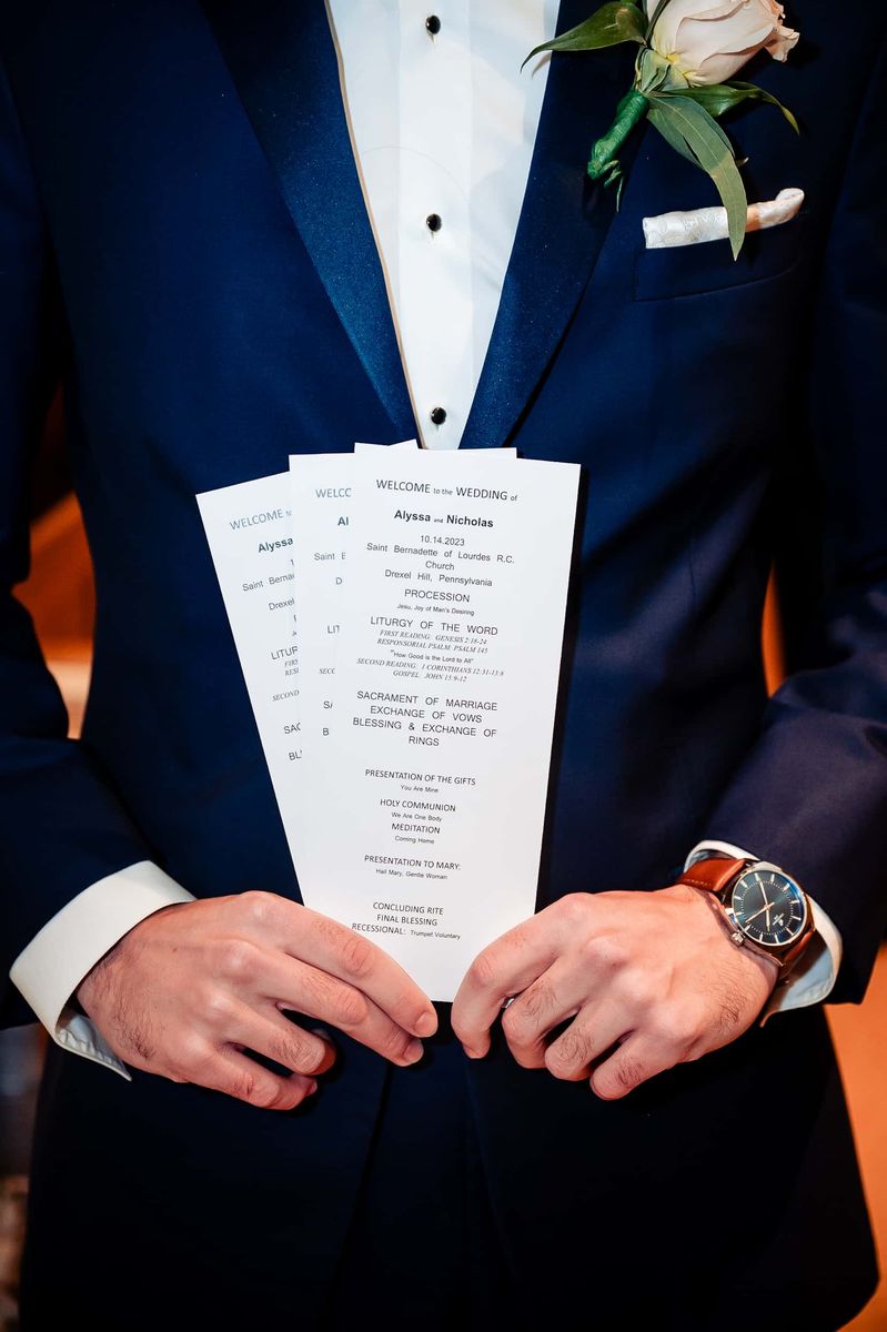 Groom holding the ceremony program
