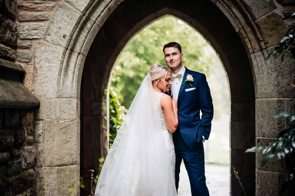 Couple embracing in a gothic doorway