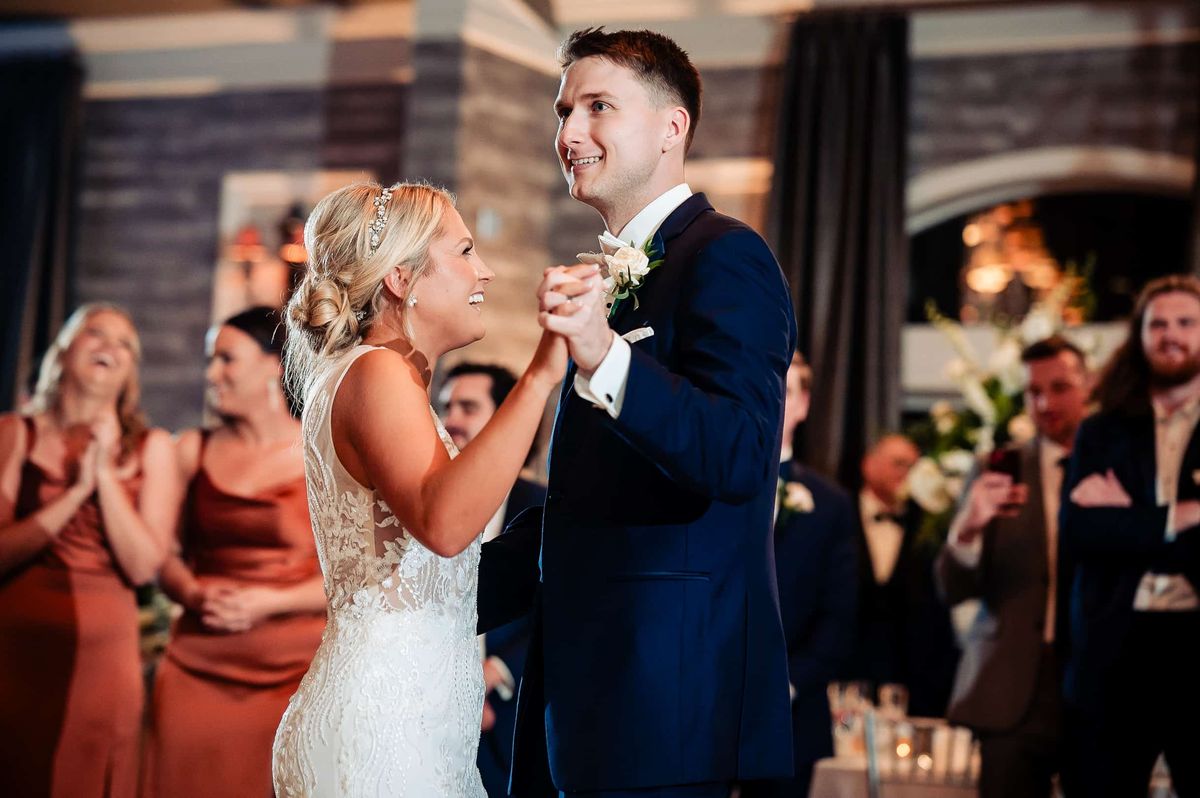 Couple dancing surrounded by the bridesmaids
