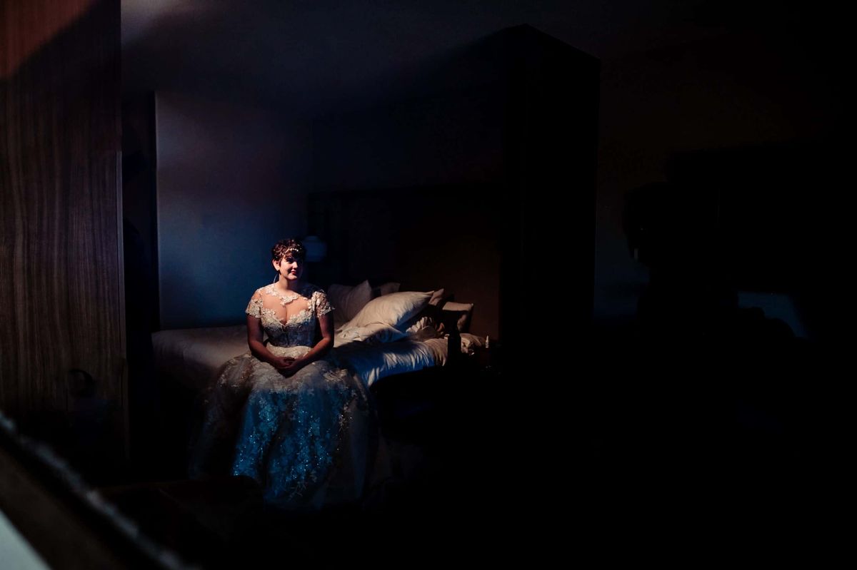 Bride seated in a softly lit room