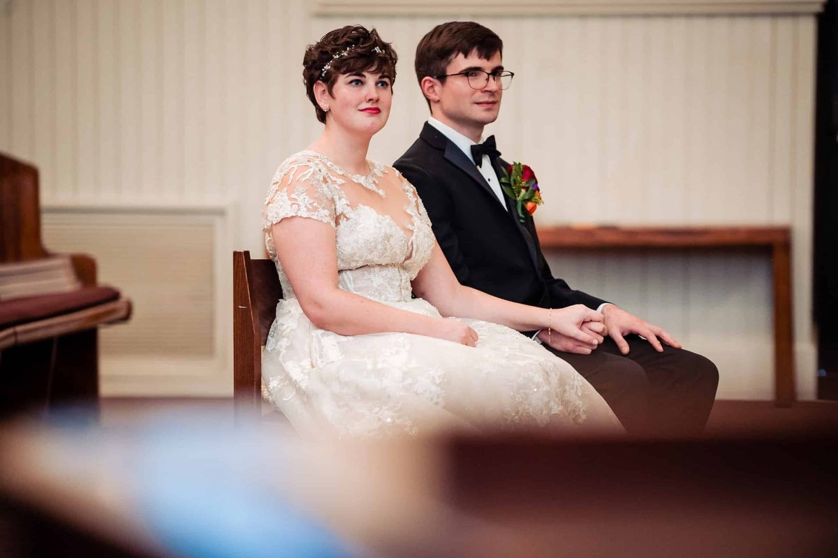 Bride and groom seated during the ceremony