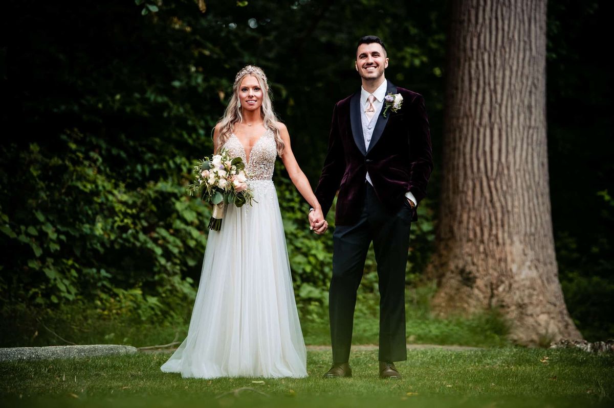 Couple on the lawn beside a tall tree