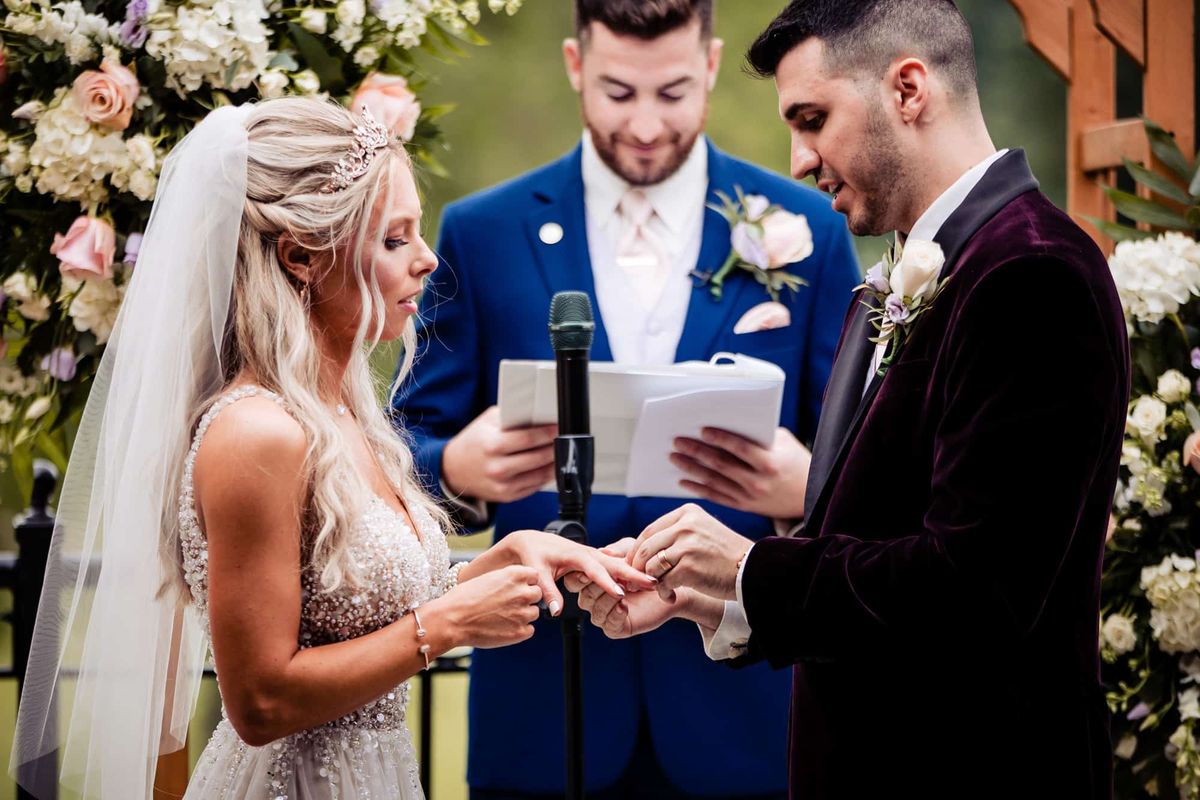 Exchanging rings under the floral arbor