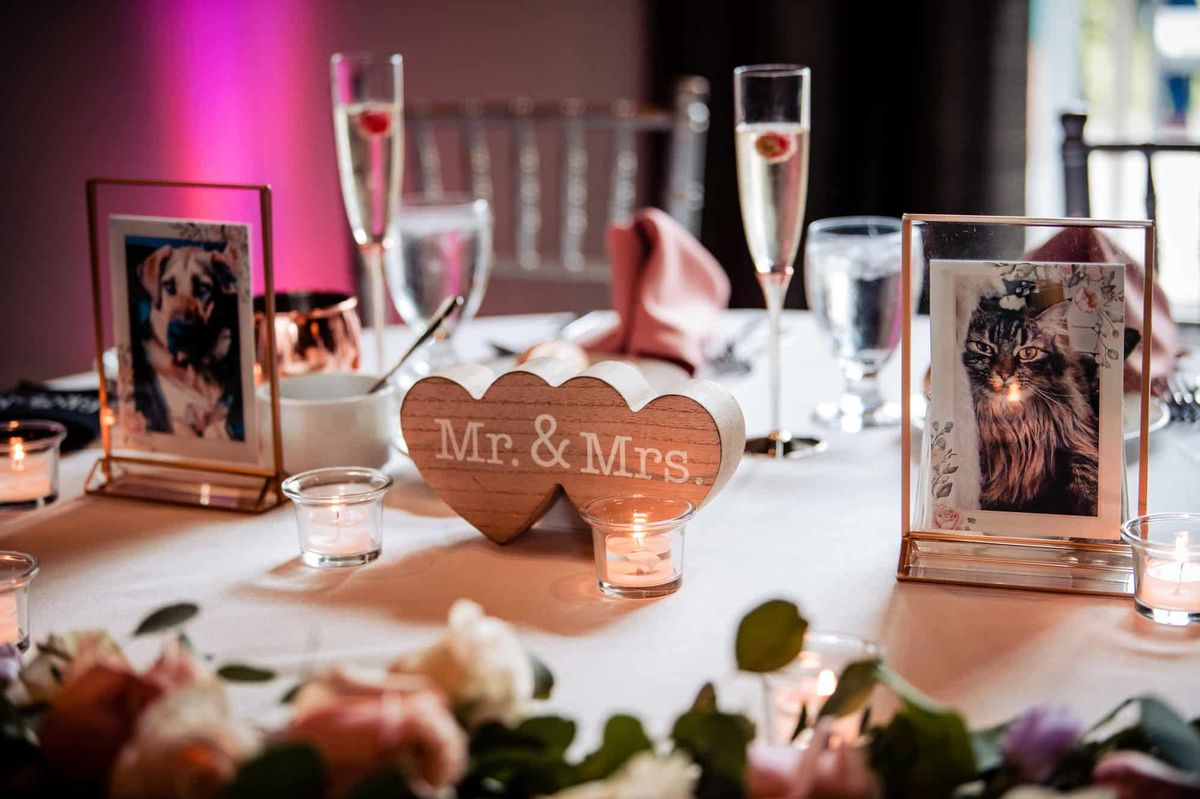 Mr & Mrs sweetheart table with framed photos