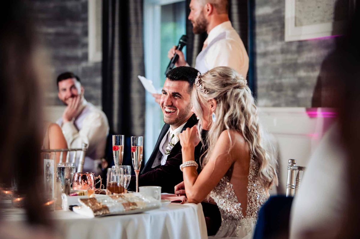 Couple enjoying the toasts at the sweetheart table