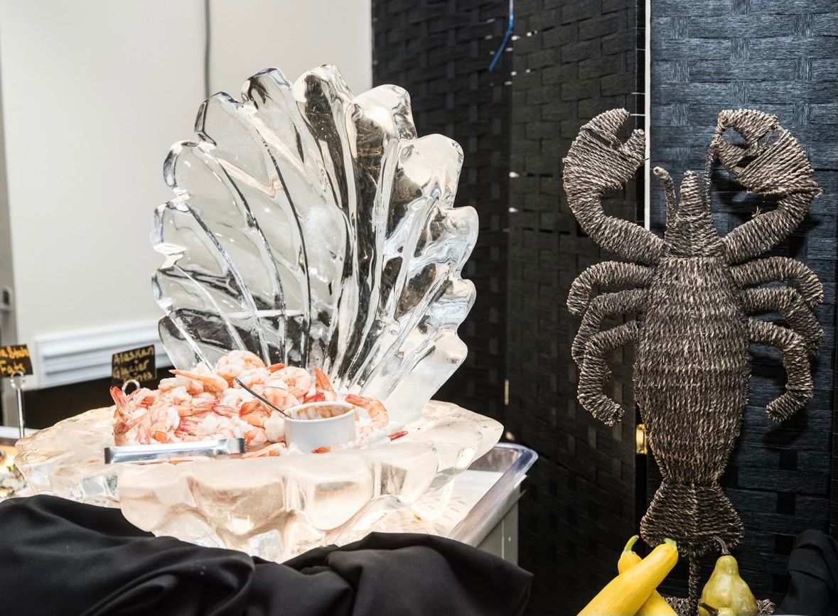 Raw bar on ice beside a carved ice shell