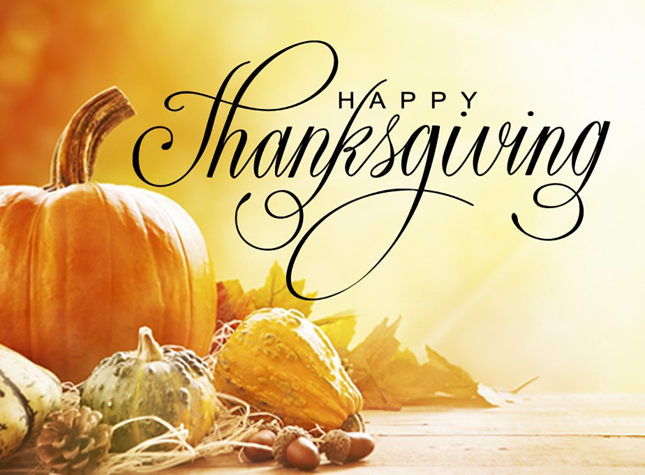 Happy Thanksgiving: pumpkins, gourds and autumn leaves on a sunlit wooden table
