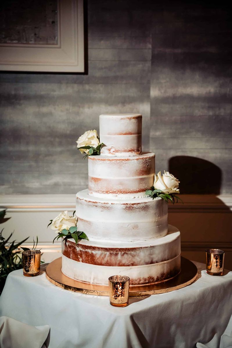 Naked wedding cake with copper accents